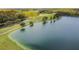 Aerial view of a lake alongside a golf course at 25406 Lexington Oaks Blvd, Wesley Chapel, FL 33544