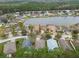 Community overview showing houses, a lake, and lush greenery at 25406 Lexington Oaks Blvd, Wesley Chapel, FL 33544