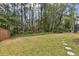 Spacious backyard with mature trees and wooden fence at 25406 Lexington Oaks Blvd, Wesley Chapel, FL 33544