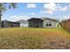 Backyard view of home with covered patio and fence at 25406 Lexington Oaks Blvd, Wesley Chapel, FL 33544