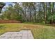 Large backyard with trees and flagstone patio at 25406 Lexington Oaks Blvd, Wesley Chapel, FL 33544