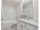 Bright bathroom with white vanity, toilet, and bathtub shower combo at 25406 Lexington Oaks Blvd, Wesley Chapel, FL 33544