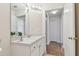 Clean bathroom with vanity, large mirror, and access to hallway at 25406 Lexington Oaks Blvd, Wesley Chapel, FL 33544