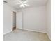 Well-lit bedroom with neutral walls, carpet flooring, and an additional door at 25406 Lexington Oaks Blvd, Wesley Chapel, FL 33544