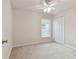 Spacious bedroom featuring neutral walls, ceiling fan, and window with blinds at 25406 Lexington Oaks Blvd, Wesley Chapel, FL 33544