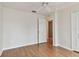 Simple bedroom with wood flooring and door to bathroom at 25406 Lexington Oaks Blvd, Wesley Chapel, FL 33544