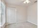 Bright bedroom with neutral walls, carpet, ceiling fan, and double door closet at 25406 Lexington Oaks Blvd, Wesley Chapel, FL 33544