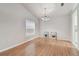 Bright dining room with hardwood floors and kitchen access at 25406 Lexington Oaks Blvd, Wesley Chapel, FL 33544