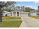 Two-story house with a driveway and landscaping at 25406 Lexington Oaks Blvd, Wesley Chapel, FL 33544