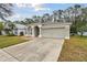 Front view of a house with a garage and landscaping at 25406 Lexington Oaks Blvd, Wesley Chapel, FL 33544