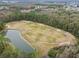 Aerial view of a golf course with a pond at 25406 Lexington Oaks Blvd, Wesley Chapel, FL 33544