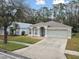 Charming one-story house with attached garage and manicured lawn at 25406 Lexington Oaks Blvd, Wesley Chapel, FL 33544