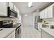 Modern kitchen with stainless steel appliances and white cabinetry at 25406 Lexington Oaks Blvd, Wesley Chapel, FL 33544