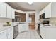 Updated kitchen with stainless steel appliances and white cabinetry at 25406 Lexington Oaks Blvd, Wesley Chapel, FL 33544
