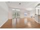 Open living space with hardwood floors and views to dining area and kitchen at 25406 Lexington Oaks Blvd, Wesley Chapel, FL 33544
