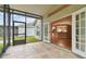 Screened porch with tile flooring, opens to living area and backyard at 25406 Lexington Oaks Blvd, Wesley Chapel, FL 33544