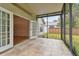 Spacious screened porch with tiled floor and access to backyard at 25406 Lexington Oaks Blvd, Wesley Chapel, FL 33544