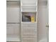 Bright walk-in closet with built-in shelves and drawers at 25406 Lexington Oaks Blvd, Wesley Chapel, FL 33544