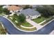 Single-Gathering house with gray roof, situated on a tree-lined street at 27325 Mistflower Dr, Wesley Chapel, FL 33544