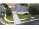 Single-Gathering home with a gray roof and brick paver driveway at 27325 Mistflower Dr, Wesley Chapel, FL 33544
