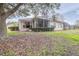 House exterior showcasing backyard with screened patio and lush landscaping at 27325 Mistflower Dr, Wesley Chapel, FL 33544