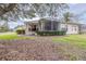 House exterior showcasing backyard with screened patio and lush landscaping at 27325 Mistflower Dr, Wesley Chapel, FL 33544