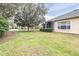 House exterior showcasing backyard with screened patio and lush landscaping at 27325 Mistflower Dr, Wesley Chapel, FL 33544