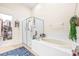 Relaxing bathroom with soaking tub, walk-in shower, and separate closet at 27325 Mistflower Dr, Wesley Chapel, FL 33544
