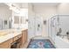 Bright bathroom with double vanity, walk-in shower, and large closet at 27325 Mistflower Dr, Wesley Chapel, FL 33544
