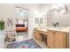 Double vanity bathroom with a view into the bedroom and walk-in closet at 27325 Mistflower Dr, Wesley Chapel, FL 33544