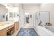 Elegant bathroom with double vanity, walk-in shower, and soaking tub at 27325 Mistflower Dr, Wesley Chapel, FL 33544