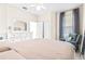 Spacious bedroom with a queen bed and large window at 27325 Mistflower Dr, Wesley Chapel, FL 33544