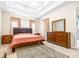 Spacious bedroom with king bed and wood furniture at 27325 Mistflower Dr, Wesley Chapel, FL 33544