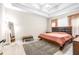 Main bedroom with king bed, wood dresser and large mirror at 27325 Mistflower Dr, Wesley Chapel, FL 33544