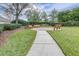 Quaint community park with two benches and a brick paved pathway at 27325 Mistflower Dr, Wesley Chapel, FL 33544