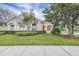 Two-story house with manicured lawn and driveway at 27325 Mistflower Dr, Wesley Chapel, FL 33544
