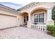 Front entry with columns,balustrade, and brick driveway at 27325 Mistflower Dr, Wesley Chapel, FL 33544