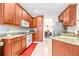 Spacious kitchen with granite counters and wood cabinets at 27325 Mistflower Dr, Wesley Chapel, FL 33544