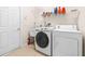 Laundry room with washer, dryer, and utility sink at 27325 Mistflower Dr, Wesley Chapel, FL 33544