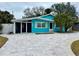 Light blue house with a spacious paved driveway and palm trees at 2827 Miriam S St, Gulfport, FL 33711