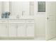 Elegant bathroom with white cabinets, quartz countertops, and tile shower at 31537 Cardinal Yard Dr, San Antonio, FL 33576