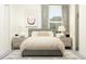 Cozy bedroom with gray platform bed, neutral decor and natural light at 31537 Cardinal Yard Dr, San Antonio, FL 33576