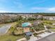 Aerial view of community amenities, including pool, playground, and pond at 36060 Carriage Pine Ct, Zephyrhills, FL 33541