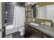 Modern bathroom with dark tile,granite vanity, and bathtub at 400 4Th S Ave # 506, St Petersburg, FL 33701