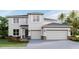 Two-story house with light-colored walls, dark gray roof, and two-car garage at 4319 Pullet Ct, Bradenton, FL 34211