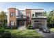 Modern two-story home with wood and stone accents, balconies, and a two-car garage at 4621 W El Prado Blvd, Tampa, FL 33629