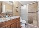 Bathroom with granite countertop, wood cabinets, and a shower stall at 5012 Starfish Se Dr # C, St Petersburg, FL 33705