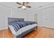 Main bedroom with grey platform bed, terracotta floors, and ceiling fan at 5012 Starfish Se Dr # C, St Petersburg, FL 33705
