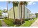 Light green building exterior with palm trees and landscaping at 5012 Starfish Se Dr # C, St Petersburg, FL 33705
