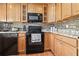 Well-equipped kitchen with granite counters and dark appliances at 5012 Starfish Se Dr # C, St Petersburg, FL 33705